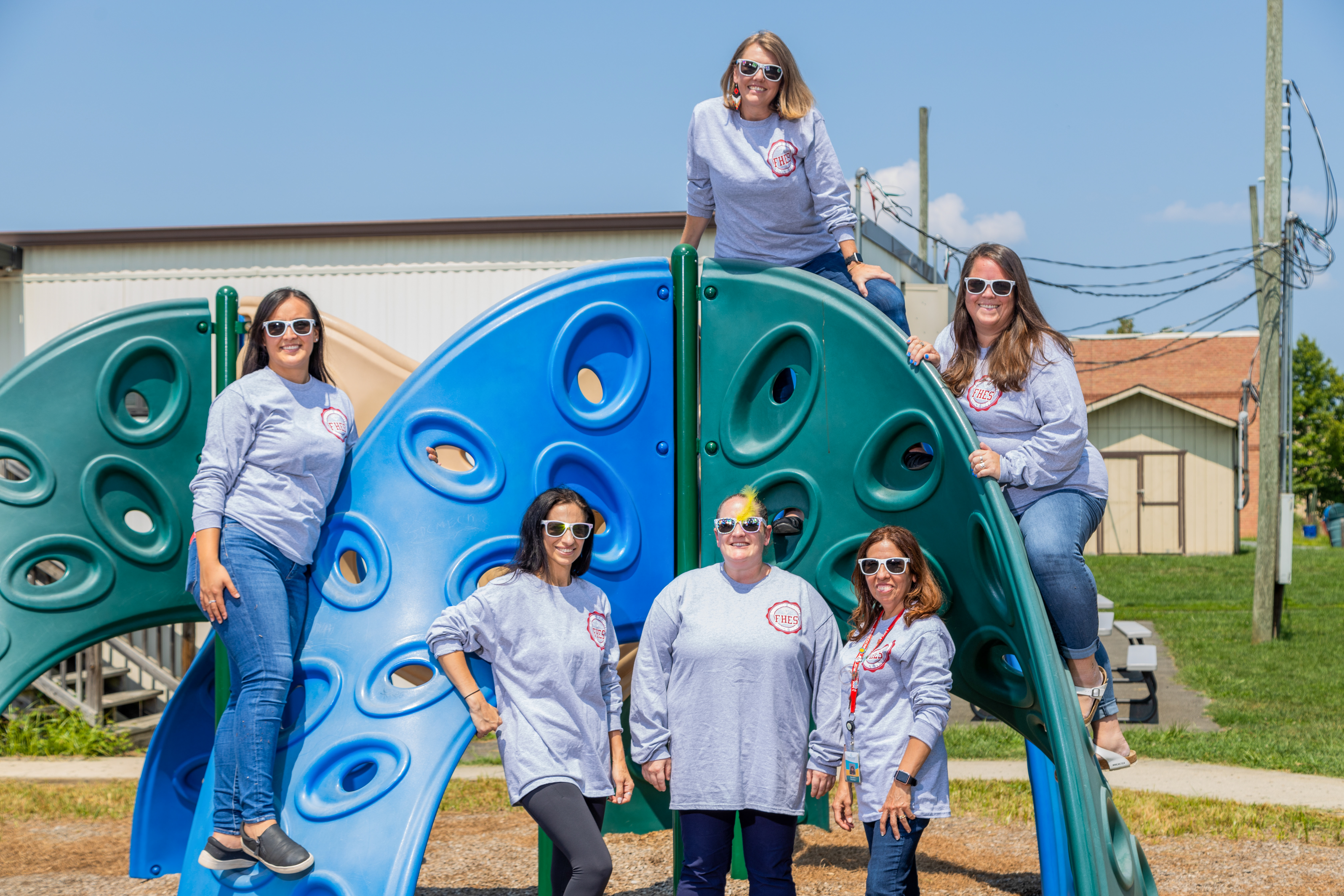 staff smiling on playground